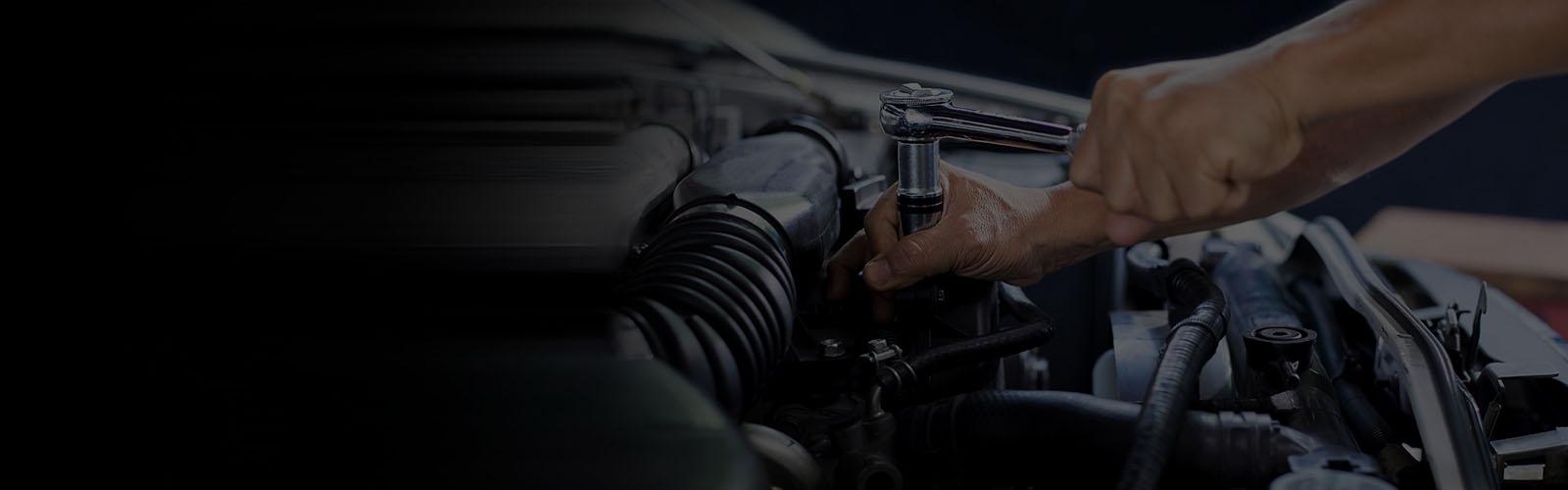 Car mechanic working on car engine